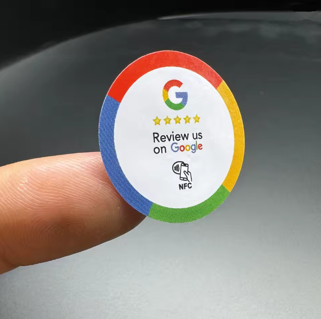 Okrągła naklejka NFC Review us on Google trzymana na palcu